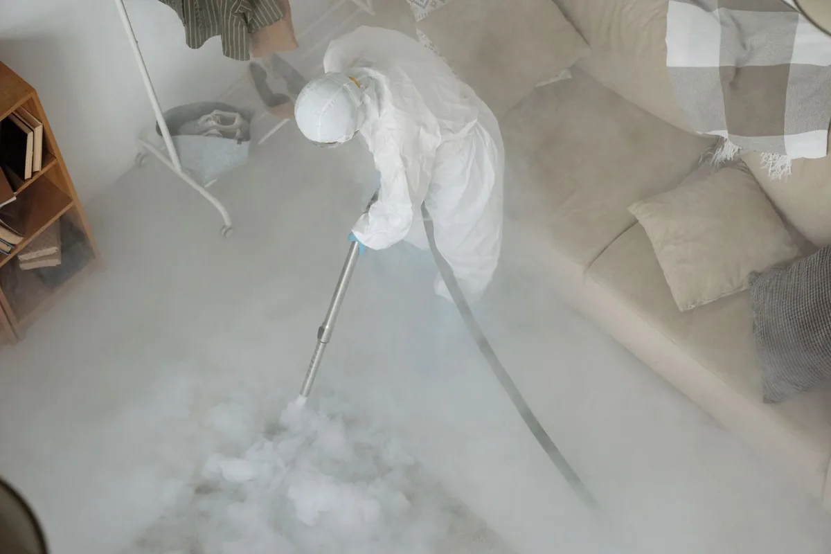 Biohazard cleanup technician in protective equipment, Park River, ND